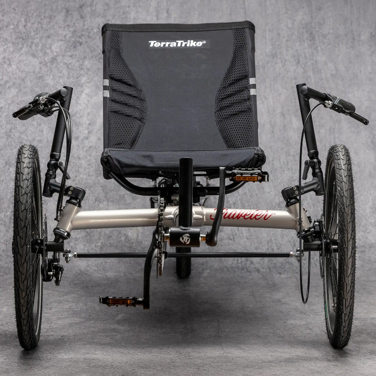 Front view of the TerraTrike Traveler Champagne Recumbent Trike against a gray background.