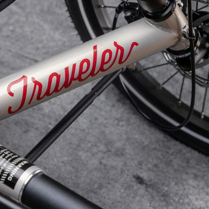 Closeup view of the frame on the TerraTrike Traveler Champagne Recumbent Trike against a gray background.