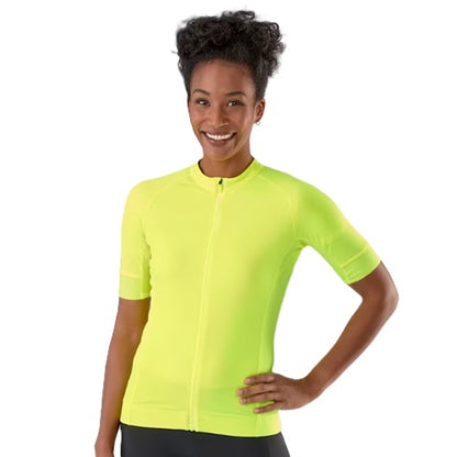 A woman wearing a bright neon yellow short-sleeve Trek Circuit cycling jersey with a full front zipper, posing against a light gray studio background.