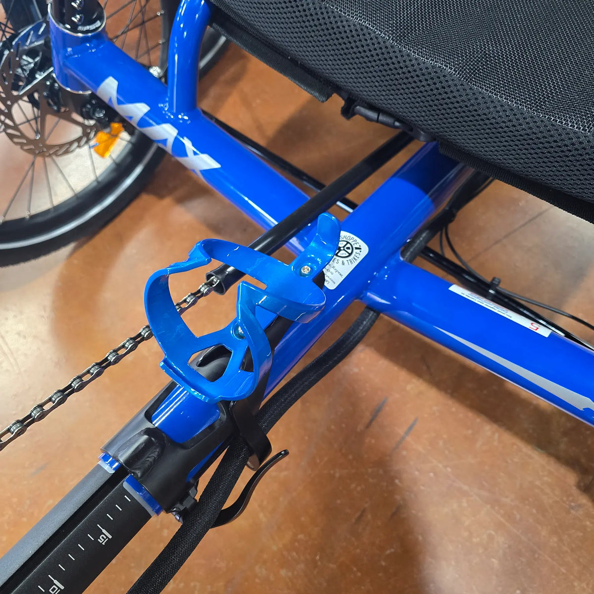 Top view of the Trek Elite Recycled Water Bottle Cage in Alpine Blue on a blue Catrike Max recumbent trike.