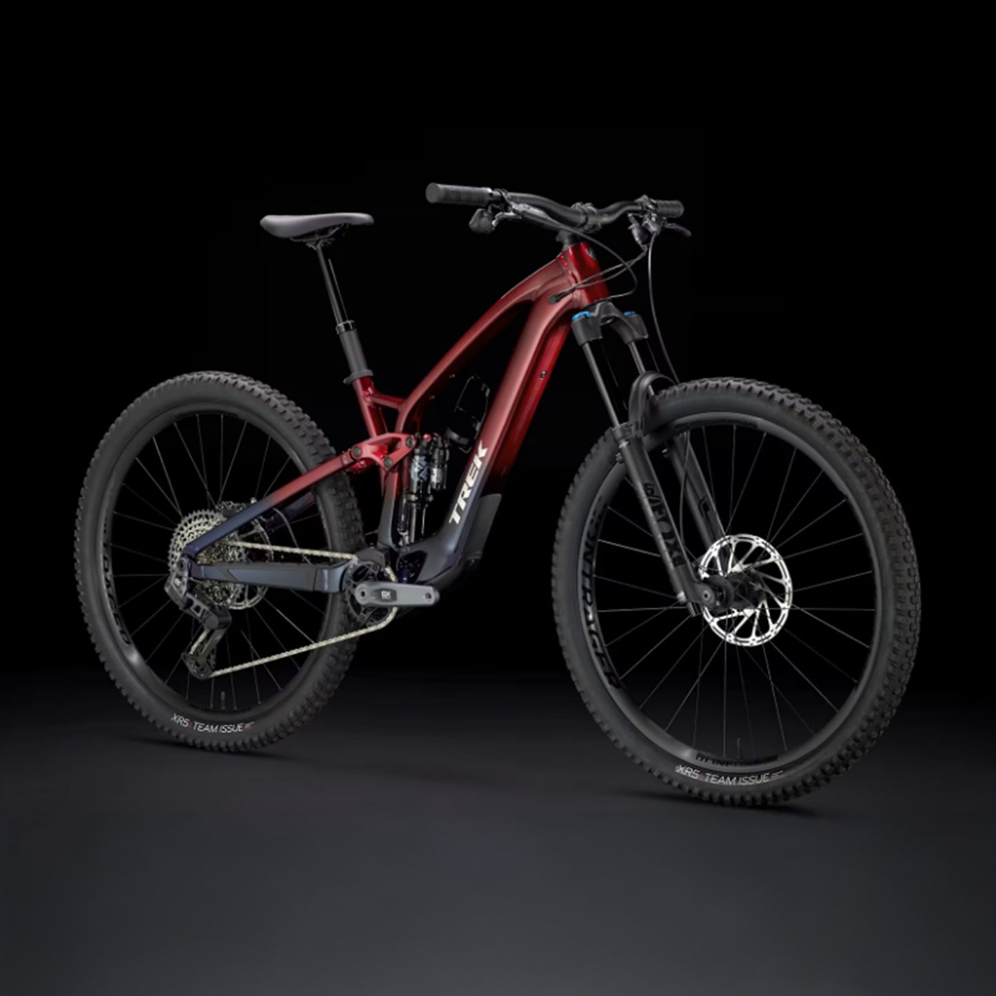 Rage red to deep dark blue fade Trek Fuel Exe 8GX AXS mountain bike on a black background.