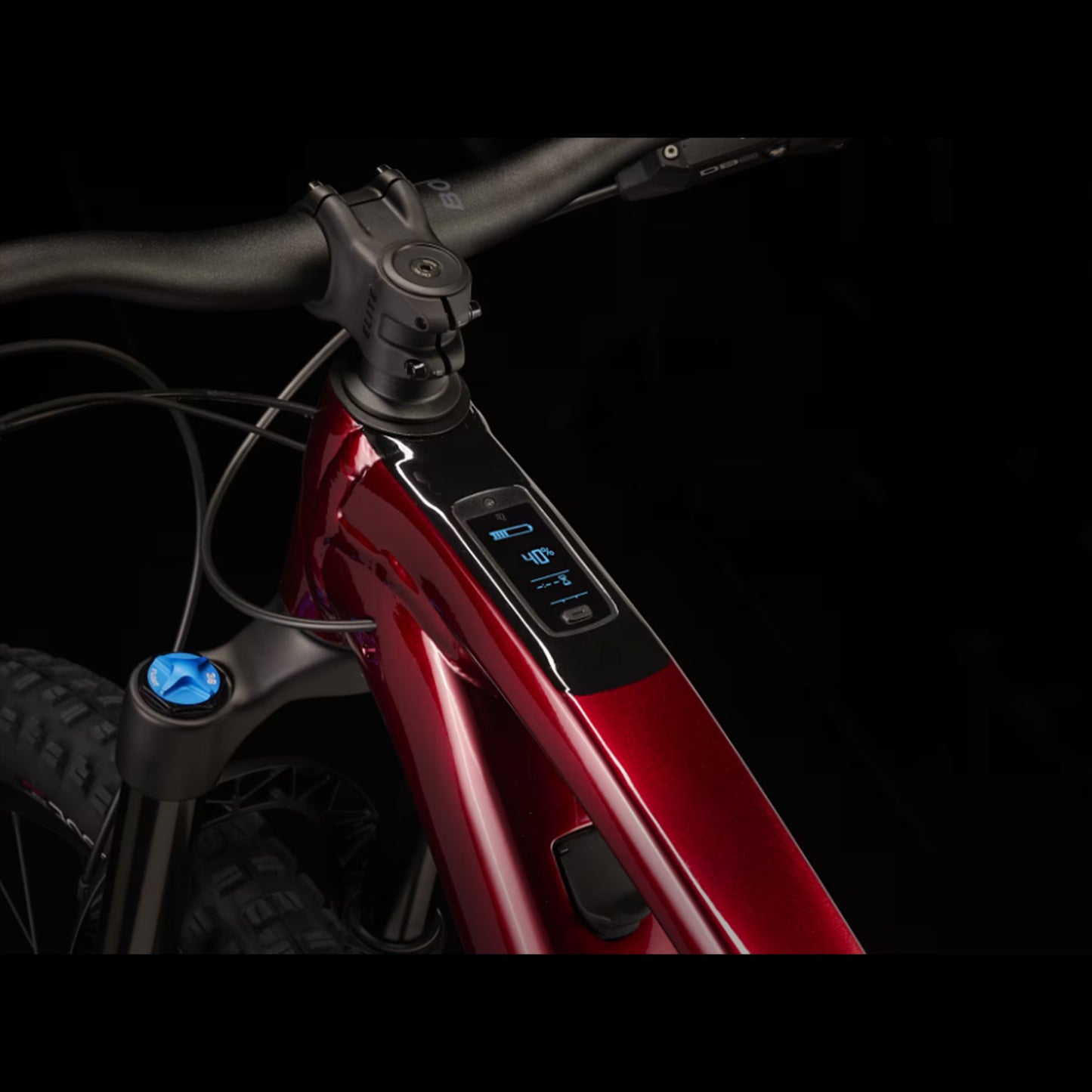 Closeup of the e-assist battery charge  on a Trek Fuel Exe 8GX AXS mountain bike on a black background.