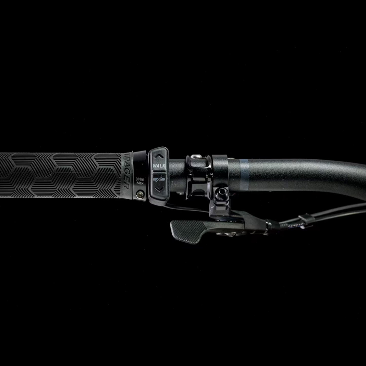 Closeup of the handlebars and shifter on a Trek Fuel Exe 8GX AXS mountain bike on a black background.