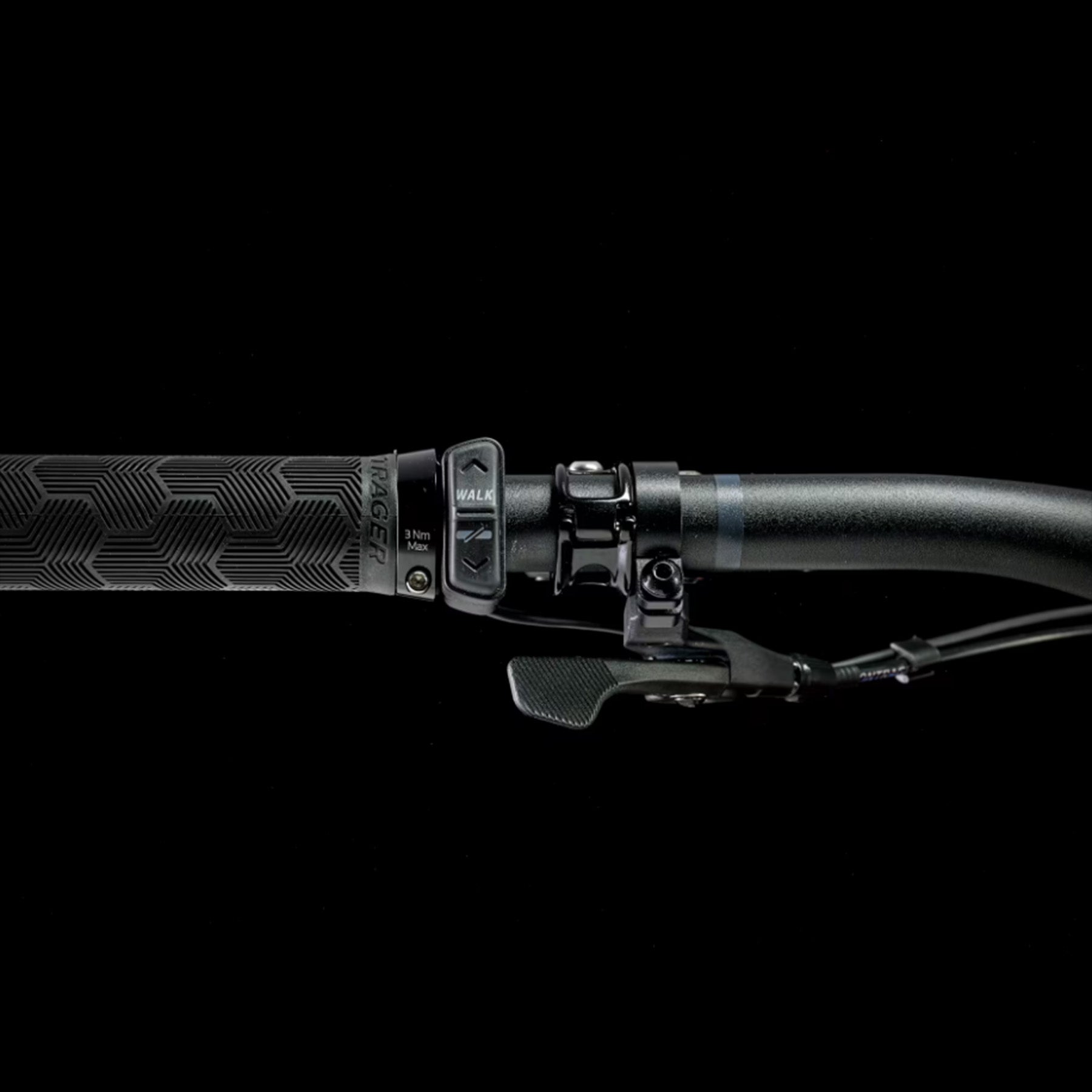 Closeup of the handlebars and shifter on a Trek Fuel Exe 8GX AXS mountain bike on a black background.