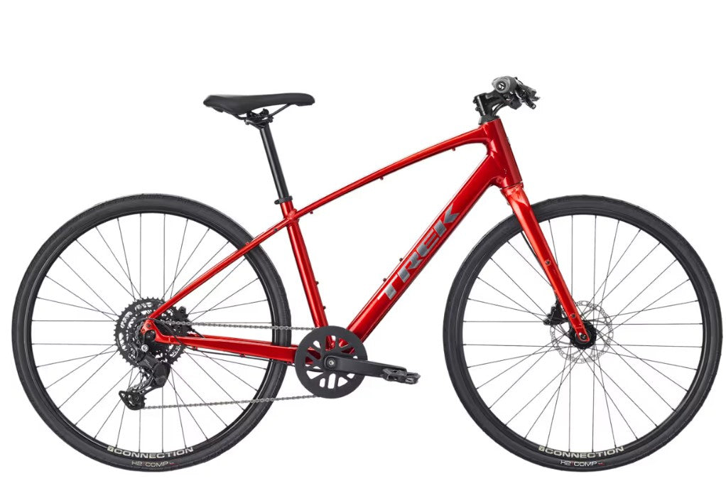 Right profile view of red Trek FX bicycle with black components on a white background. 