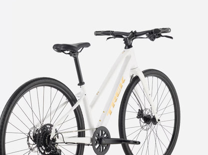 White Trek FX 2 midstep bicycle with black components on a white background.