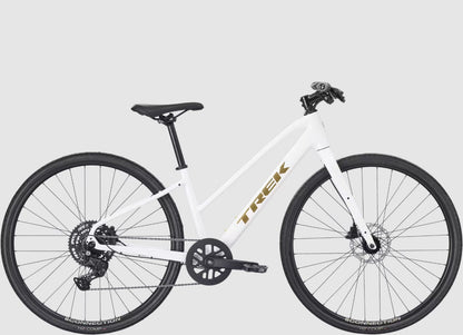 White Trek FX 2 bicycle with black components and gold 'Trek' branding on a light gray background.