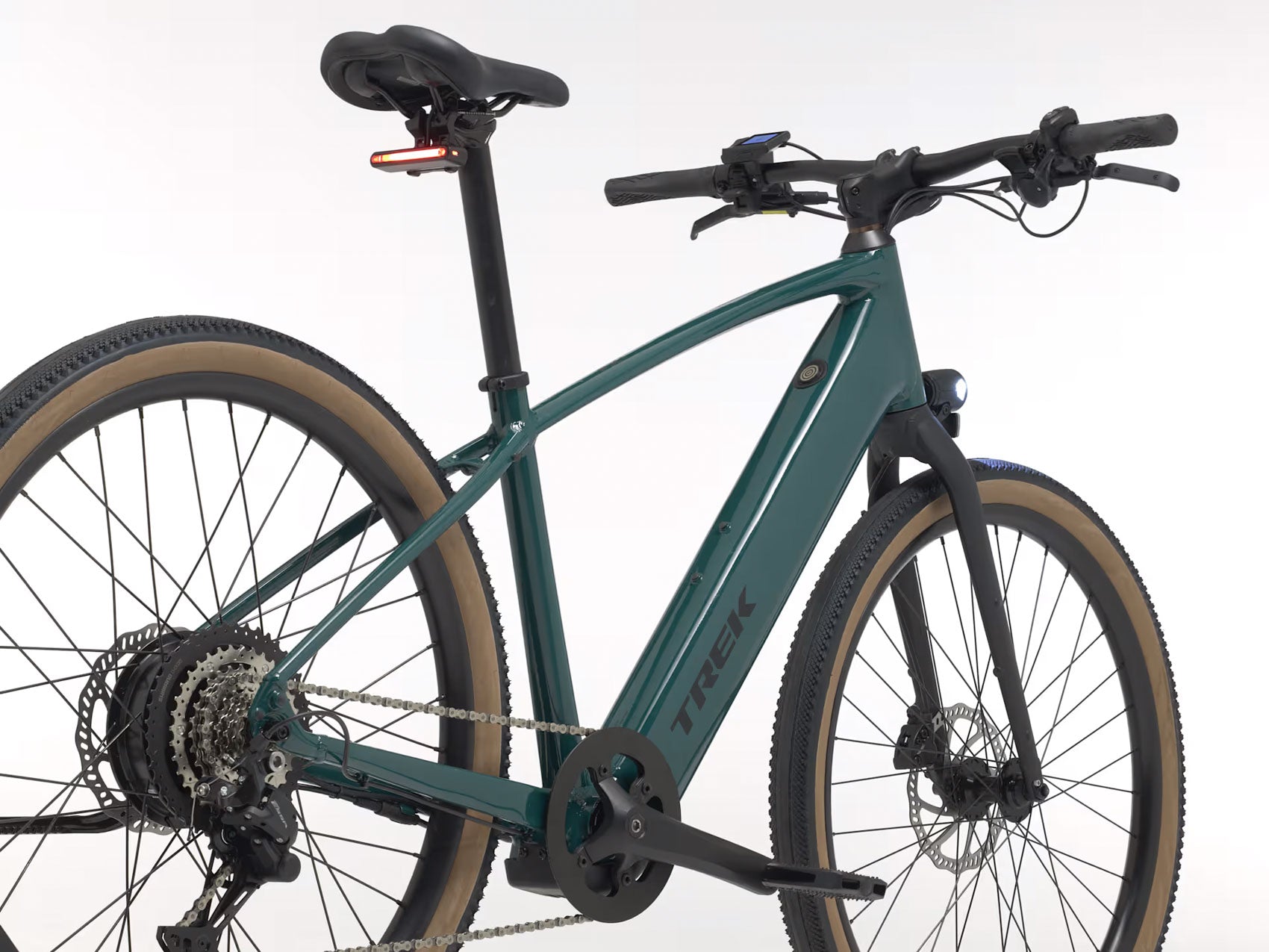 Rear quarter view of the Trek FX+ 1 Juniper e-Bike, shown on a white background.