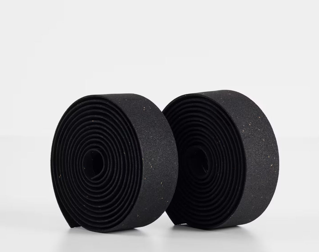 Two rolls of black Trek gel cork bicycle handlebar tape on a white background.
