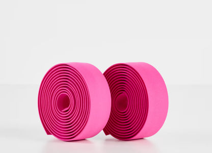 Two rolls of pink Trek gel cork bicycle handlebar tape on a white background.