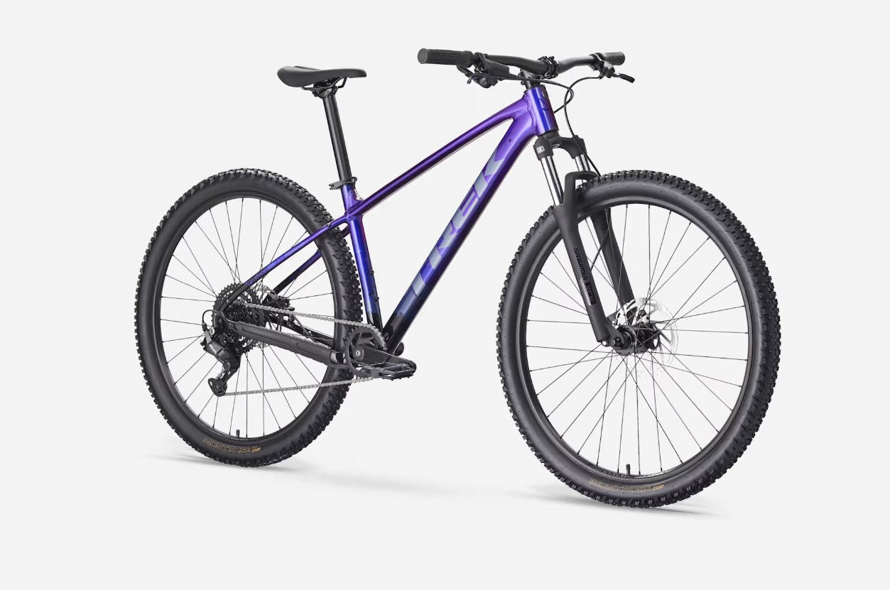 Angled view of a purple Trek Marlin 4 mountain bike on a white background
