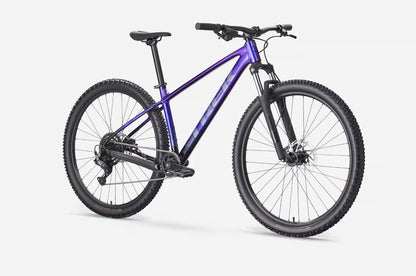Angled view of a purple Trek Marlin 4 mountain bike on a white background