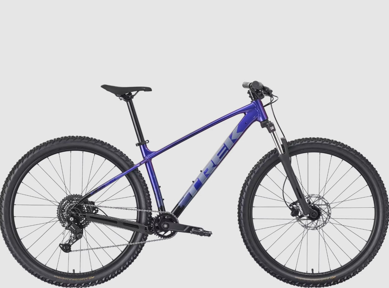 Purple Trek Marlin 4 mountain bike with black components on a gray background