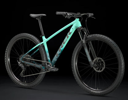 An angled view of the Trek Marlin 6 Gen 3 mountain bike in Miami Green to Dark Aquatic Fade against a black background.