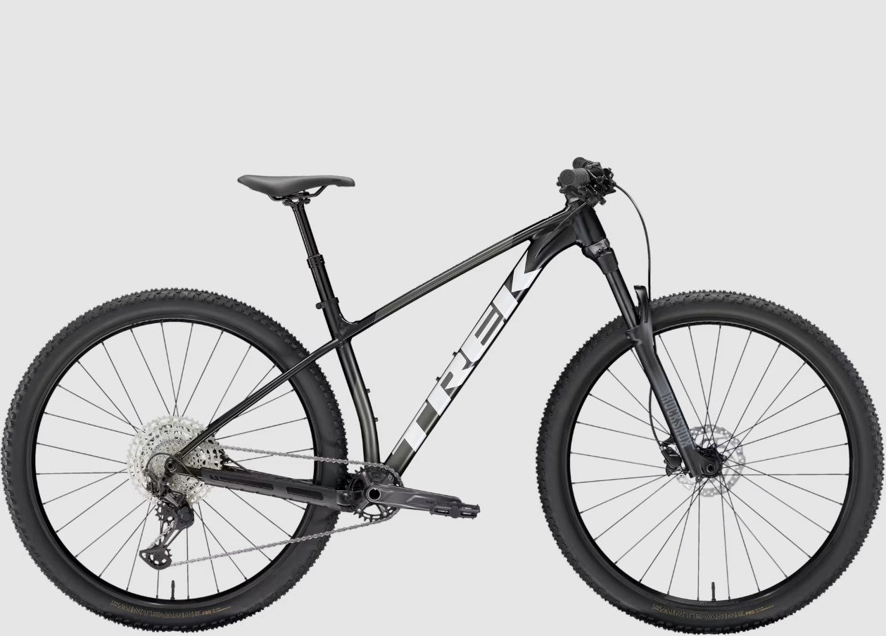 Black Trek Procaliber 6 mountain bike on a light gray background