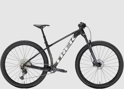 Black Trek Procaliber 6 mountain bike on a light gray background
