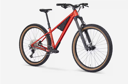 Right angled profile of red Trek Roscoe mountain bike on a white background.