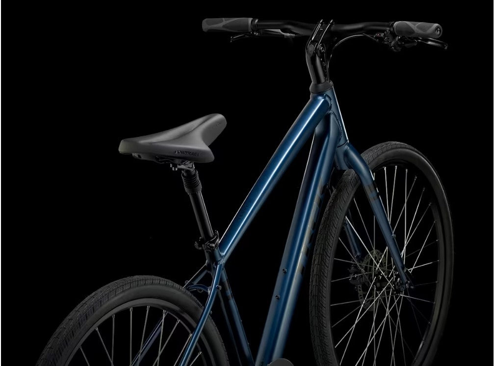 Back right view of blue Trek Verve bicycle with black components on a white background. 