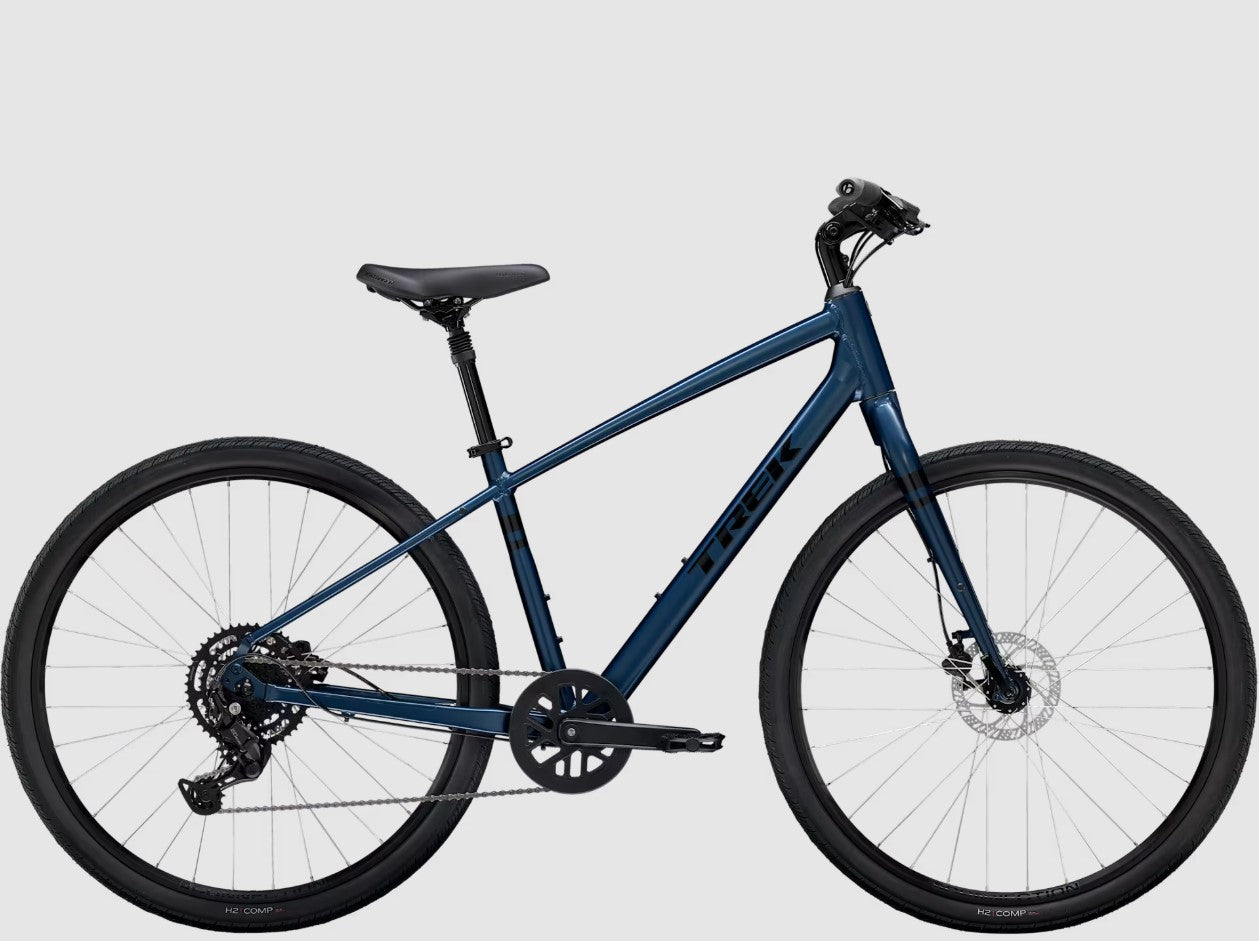 Right profile view of blue Trek Verve bicycle with black components on a white background. 