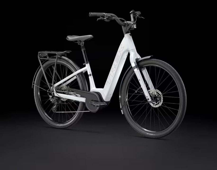 White Trek Verve Plus electric bicycle on a black background