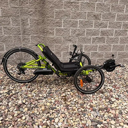 Side view of the Catrike Used 5.5.9 eCat Eon Green Recumbent Trike in an outdoor setting.