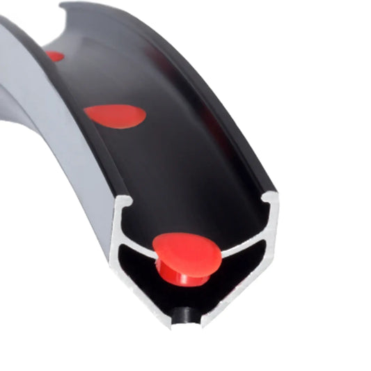Image of a red Velocity Veloplug inserted into a rim against a white background.