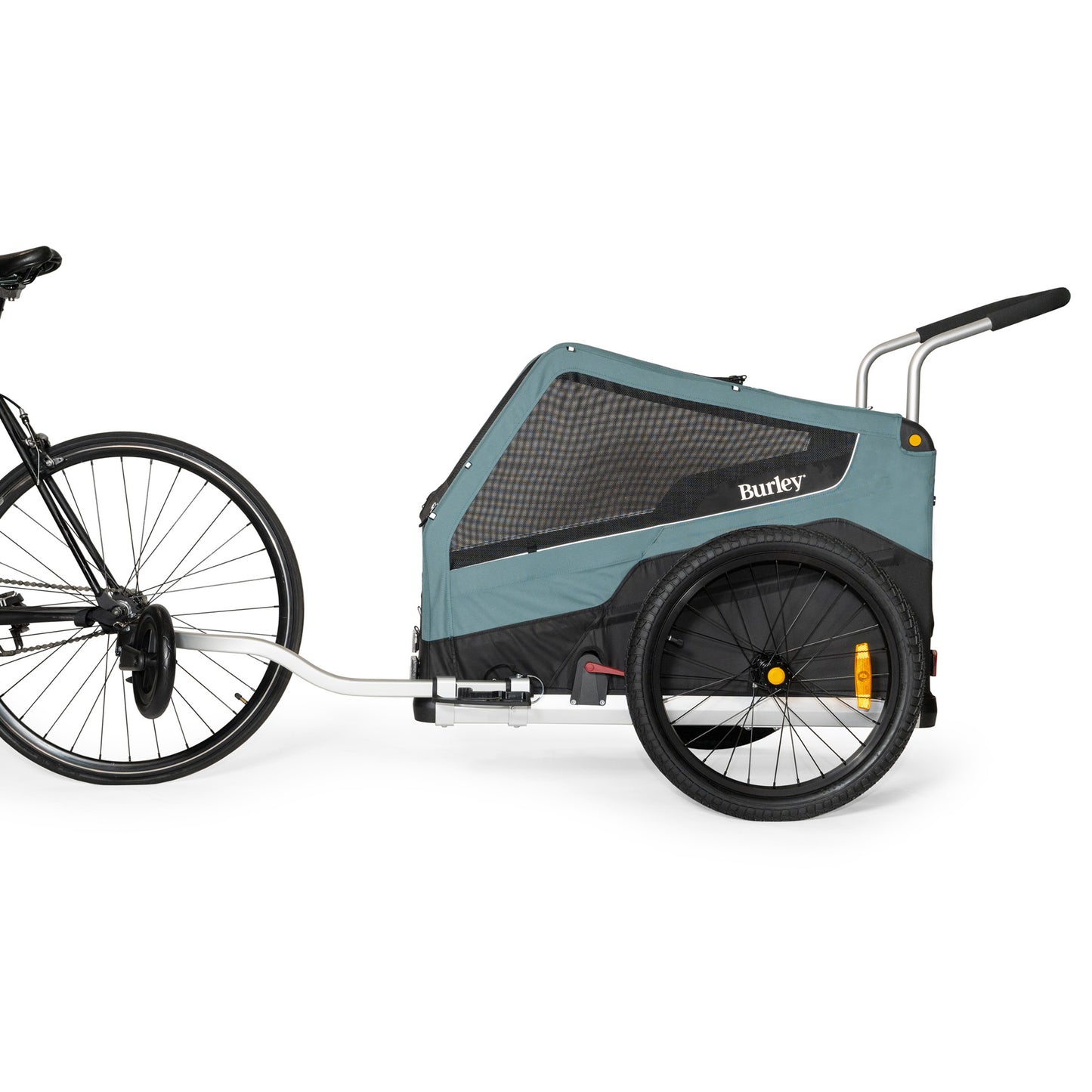Side view of the Burley Bark Ranger Pet Trailer, shown attached to a bicycle, on a white background.