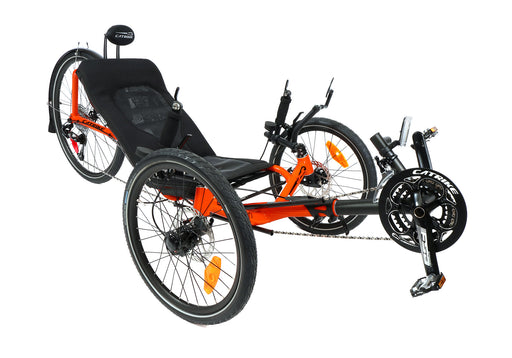 Front left angled view of a Catrike Expedition recumbent trike in bright orange color.  Can see black seat, neck rest, 20 inch front wheel, 26 inch back wheel with fender.