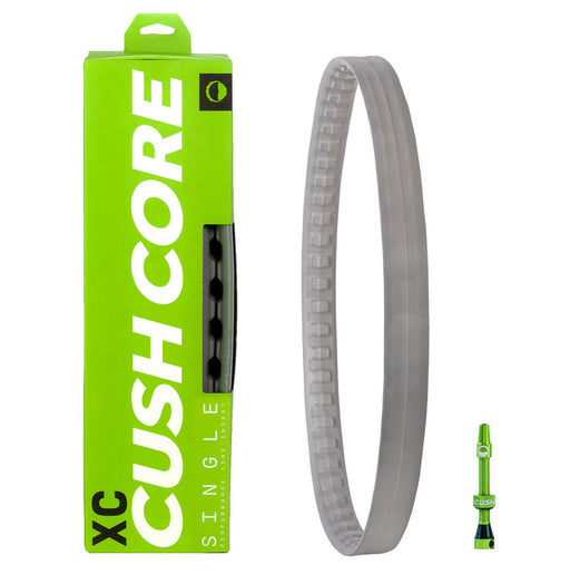 Image of the packaging box which is lime green with white and black lettering, the gray Cush Core tire insert next to the box and the green Cush Core Valve next to the box