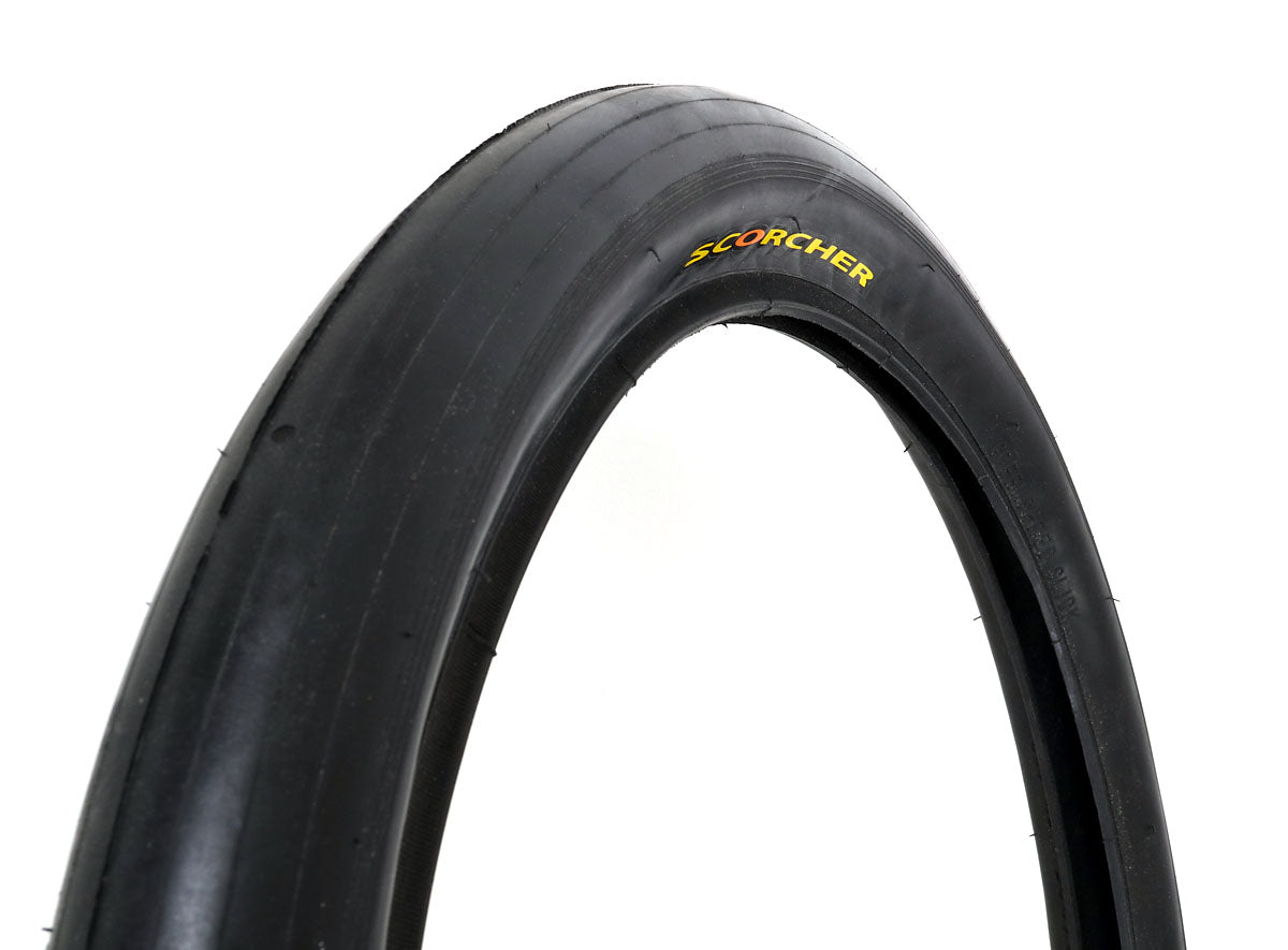A black bicycle tire with the text 'SCORCHER' visible on its side.