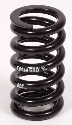 A black HP Velotechnik DV22 rear shock spring designed for mountain bikes.