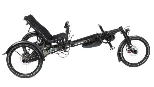 A Hase Kettwiesel Evo Shimano Steps 6100 electric recumbent trike with black coloring and large wheels, equipped with a Shimano motor and suspension system.