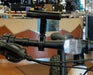 Black T-shaped mount installed on black handlebars of a bicycle