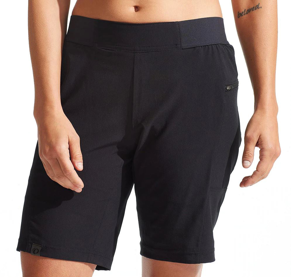 A pair of black Pearl Izumi women's cycling shorts with a wide stretch waistband and hand pockets.