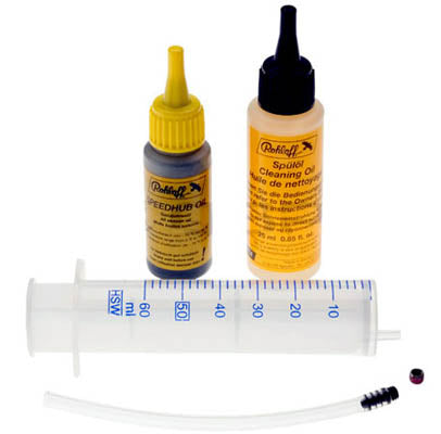 Studio image of components of Rohloff speedhub oil change kit consisting of a syringe, tube with barb and two drip bottles of cleaning fluids.