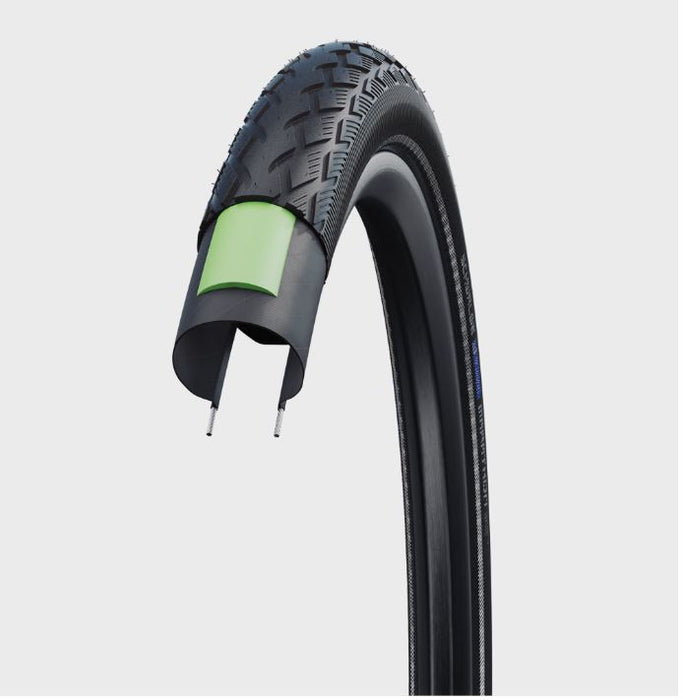 Digital image depicting the layers of  black rubber and green puncture protection layers  that make up the Schwalbe Marathon Green Guard tire.