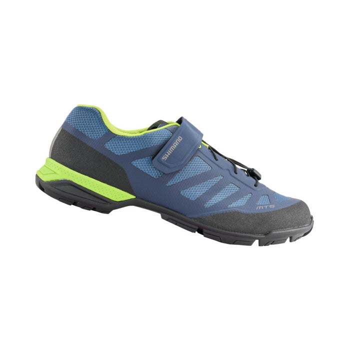 Studio image of Shimano cycling shoe with main part of shoe in navy blue, lighter blue for shoe mesh, shoe sole is black as is the toe, heel, and laces.  There is a neon green stripe on the heel of the sole and the lining of the shoe.
