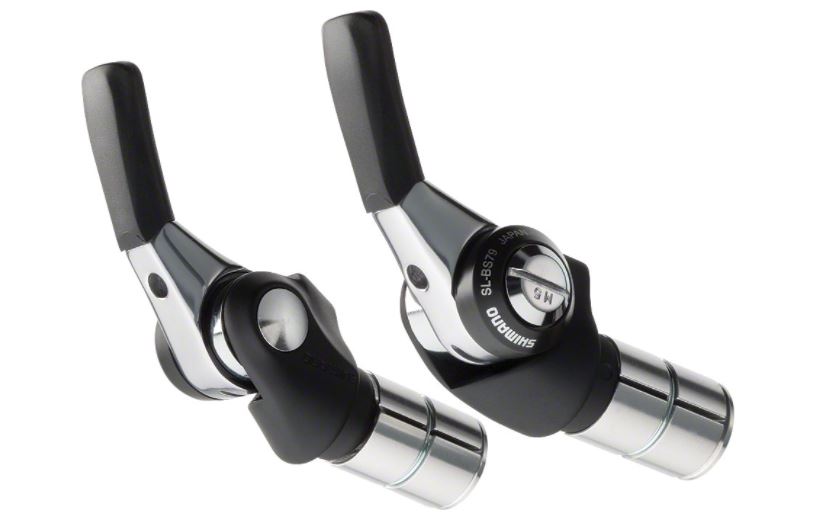 A pair of Shimano SL-BS79 Dura Ace bar end shifters, featuring black and silver colors.