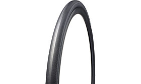 A black road bicycle tire with a visible textured tread pattern.
