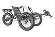 Profile view of a Sun Seeker E-fat Tad recumbent trike with three black inch fat tires with white lettering and red tire inserts. The battery is mounted on a rack at the rear of the trike.