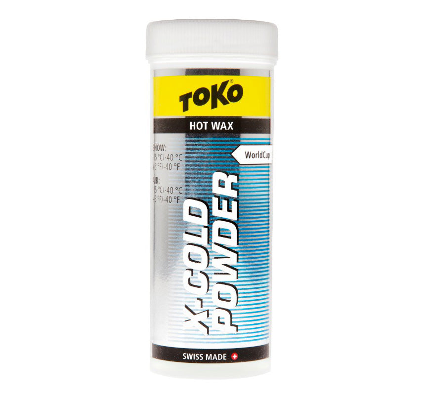 A container of Toko X-Cold Powder ski wax, which is in powder form. The container is predominantly white with blue and yellow accents and text.