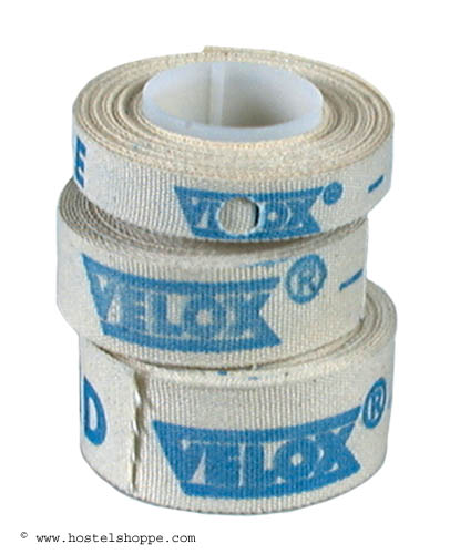 Rolls of Velox cloth rim tape for bicycle wheels, with the brand name and logo in blue on a beige background.