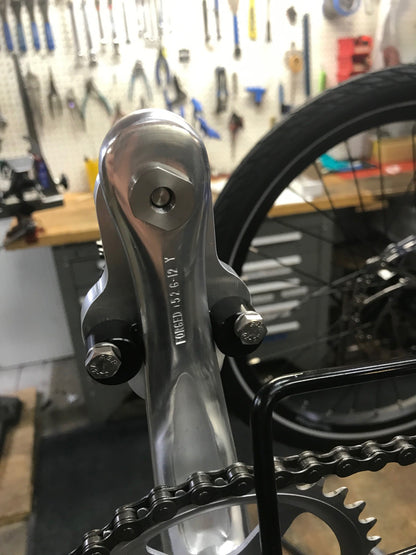 Back side view of the CJ Ackley Machine Company Crank Arm Shorteners Individual mounted on crank arm.