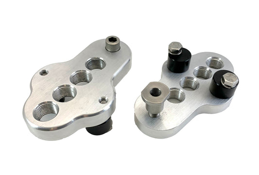 A top and bottom view of a pair of silver CJ Ackley Machine Company Wide Crank Arm Shorteners.
