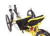 Top-down studio view of a Catrike Trail recumbent trike with a yellow frame, silver crank arms, black boom, round mirror on left side of handlebars, black seat pad, three 20 inch wheels and a black rear fender.
