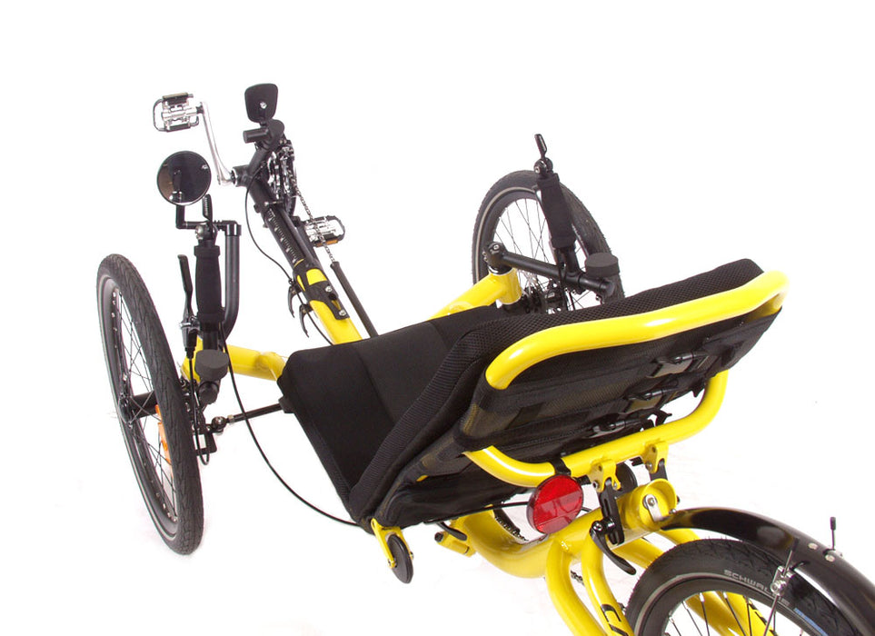 Top-down studio view of a Catrike Trail recumbent trike with a yellow frame, silver crank arms, black boom, round mirror on left side of handlebars, black seat pad, three 20 inch wheels and a black rear fender.