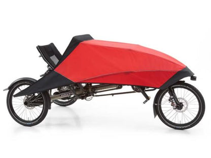 The red Hase Foldable Fairing is mounted on a Hase Trigo delta recumbent trike against a white background.