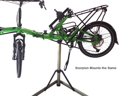 View of the HP Velotechnik Scorpion Assembly Mount Workstand Bracket attached to a green recumbent bike on a workstand against a white background.