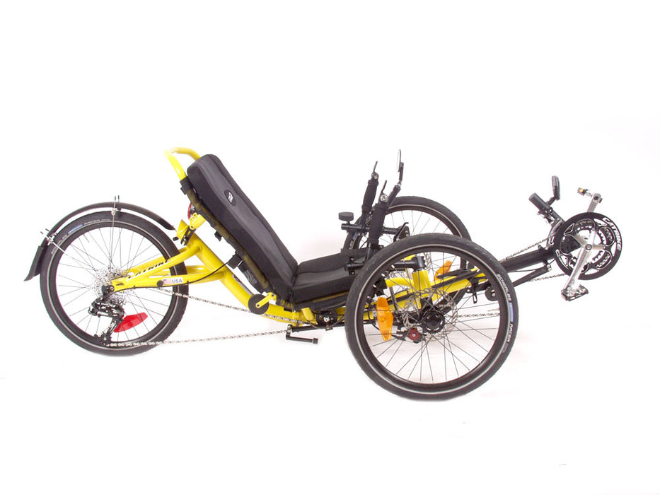 Right profile studio view of a Catrike Trail recumbent trike with a yellow frame, silver crank arms, black boom, black seat pad, three 20 inch wheels and a black rear fender.  