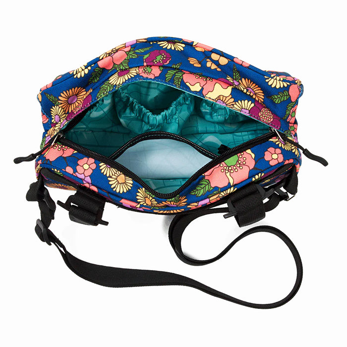 Top view of the Meadow domino handlebar bag featuring a ocean blue and white pattern inside with one large open pocket on the inner side of the front side of the bag and a zip up pocket on the back inners side of the bag.